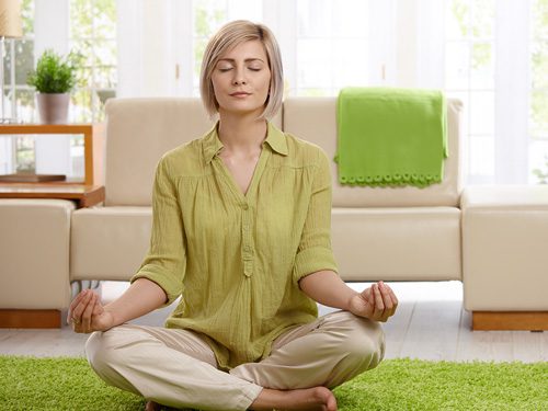 Meditation Apps for Daily Practice - woman meditating at home