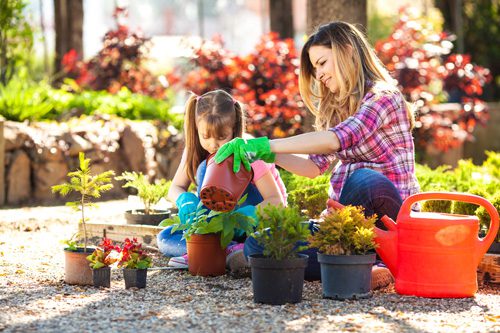 Having Family Fun While Sober - woman gardening with daughter
