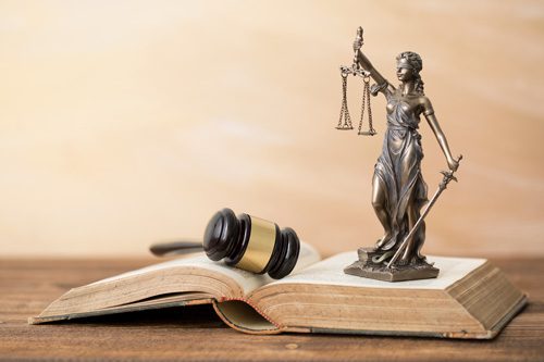 Georgia-Overdose-and-Naloxone-Laws-What-You-Need-to-Know - law book with gavel and statue lady justice