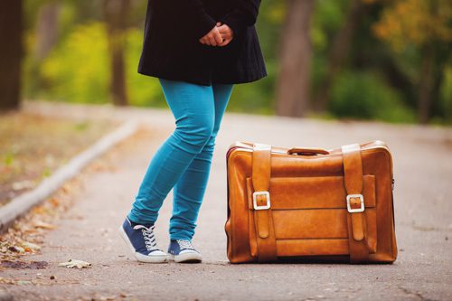 The-Importance-of-Discharge-Planning - girl standing by luggage in road