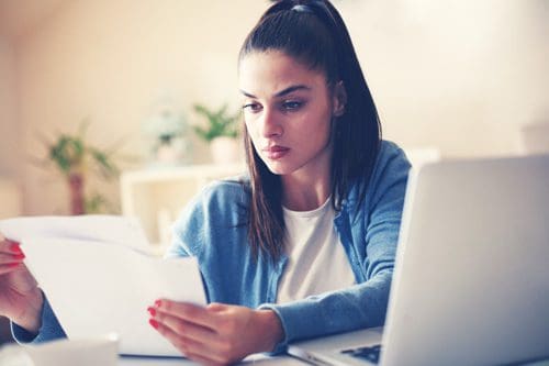 woman looking over papers