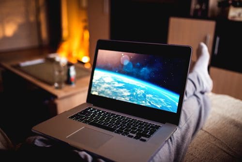 person watching video on laptop at home