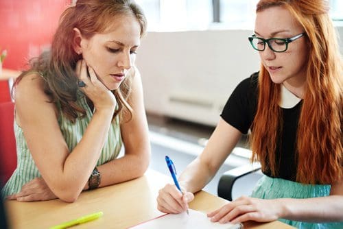 two young women studying together - sponsor