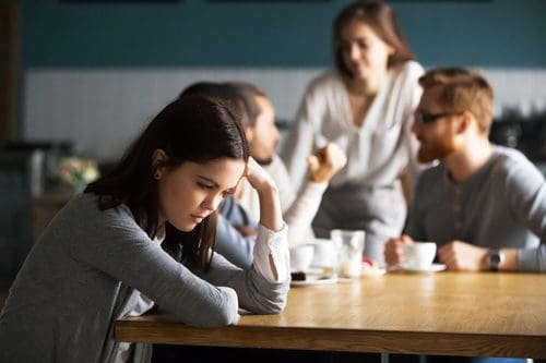 sad girl at cafe with friends