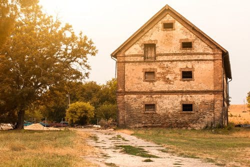 old farm house in rural south cast in golden sunshine - rural georgia