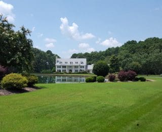 outpatient services, Atlanta Drug & Alcohol Rehab Addiction Treatment Center, gorgeous estate seen from across green lawn and lake - Twin Lakes Recovery Center - Georgia addiction treatment center,