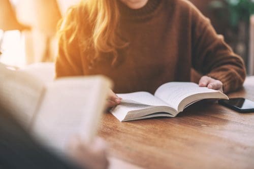 people sitting at table with open books - 12-step program