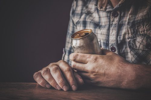 cropped shot of man holding a beer can - binge drinking