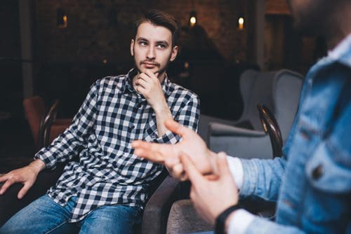 two men talking in a cafe or restaurant - alcoholism