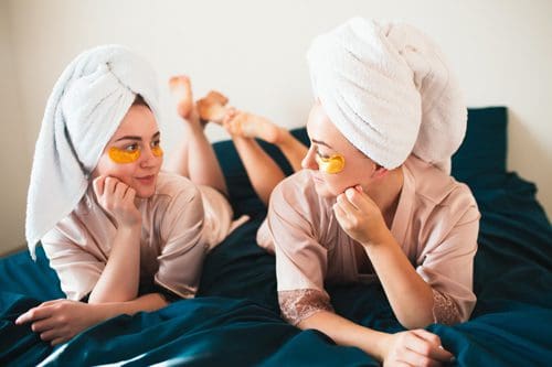 two female friends having a spa night at home - New Year's Eve