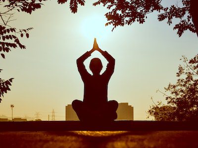 woman yoga sunset holistic treatment nature